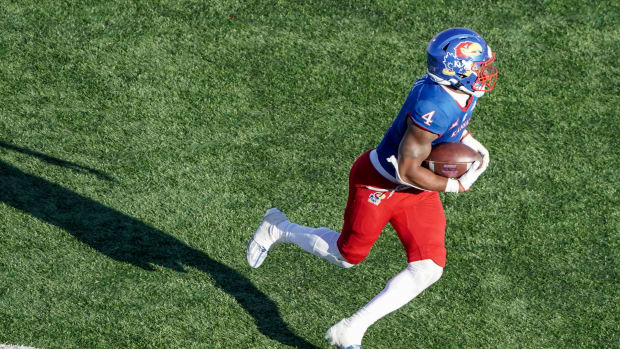 Nov 5, 2022; Lawrence, Kansas, USA; Kansas Jayhawks running back Devin Neal (4) runs the ball against the Oklahoma State Cowboys during the second half of the game at David Booth Kansas Memorial Stadium. Mandatory Credit: Denny Medley-USA TODAY Sports  